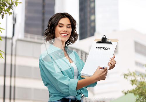 Image of smiling woman with petition on clipboard and pen