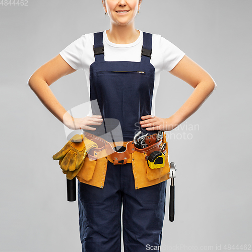 Image of female worker or builder with working tools