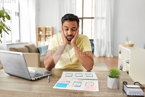 Image of male ui designer working on user interface at home