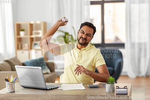 Image of angry man throwing crumpled paper at home office