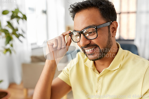 Image of happy smiling indian man in glasses at home office