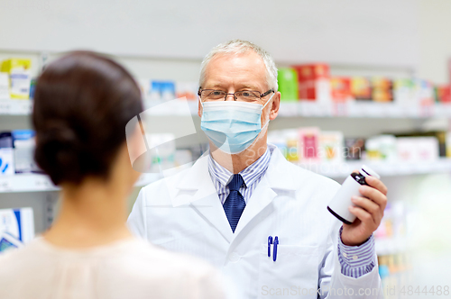 Image of apothecary in mask with drug and woman at pharmacy