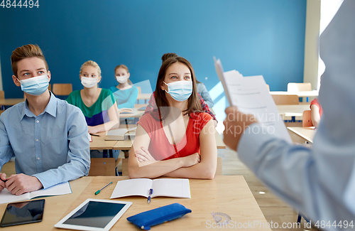 Image of group of students in masks and teacher at school