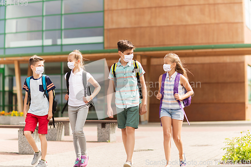 Image of group of school students in masks leaving school