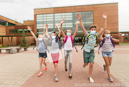 Image of group of happy students in masks leaving school