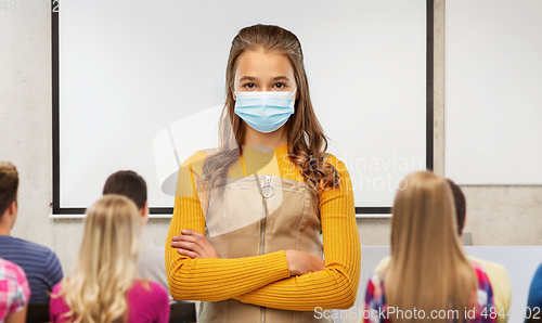 Image of student girl in mask with crossed arms at school