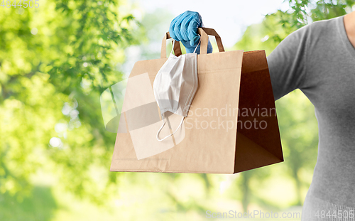 Image of woman with shopping bag, face mask and gloves