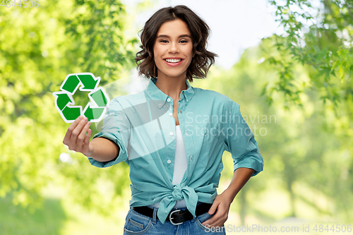 Image of smiling young woman holding green recycling sign