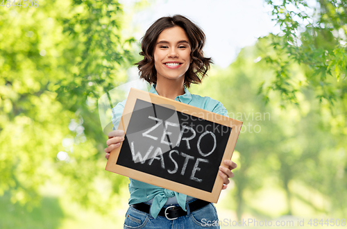 Image of happy woman with chalkboard with zero waste words