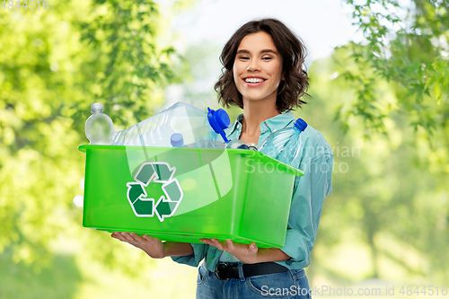 Image of smiling young woman sorting plastic waste