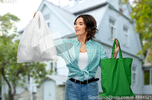 Image of woman with plastic and reusable shopping bag