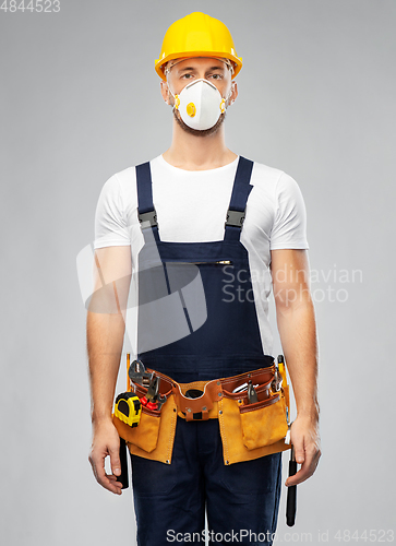 Image of male worker or builder in helmet and respirator