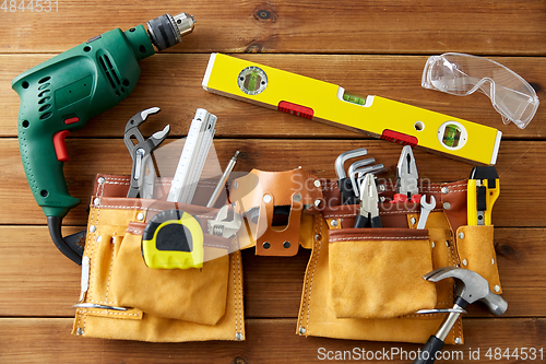 Image of different work tools on wooden boards