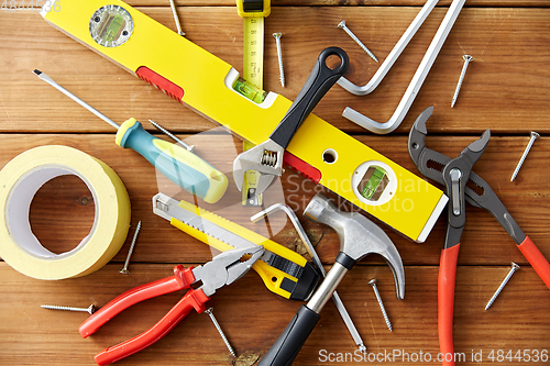 Image of different work tools on wooden boards background