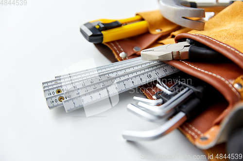 Image of different work tools in belt on white background