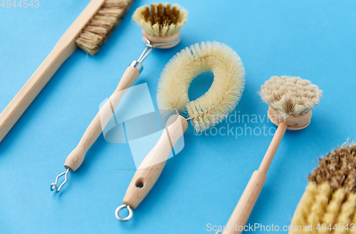 Image of different cleaning brushes on blue background