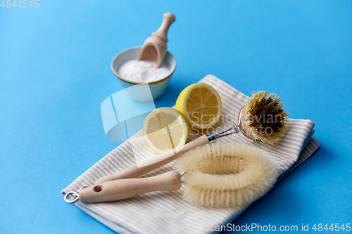 Image of cleaning brushes, lemon and washing soda on cloth