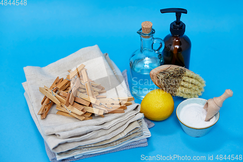 Image of baking soda, lemon, brush, vinegar and clothespins