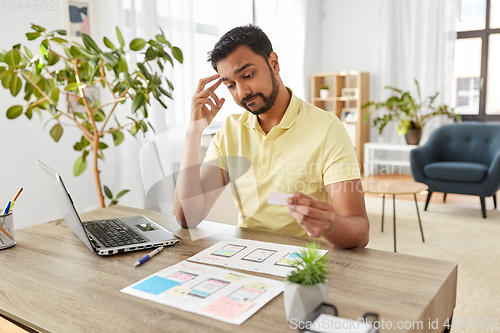 Image of male ui designer working on user interface at home