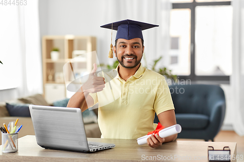 Image of indian student with laptop and diploma at home