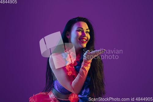 Image of Attractive hawaiian brunette model on purple studio background in neon light