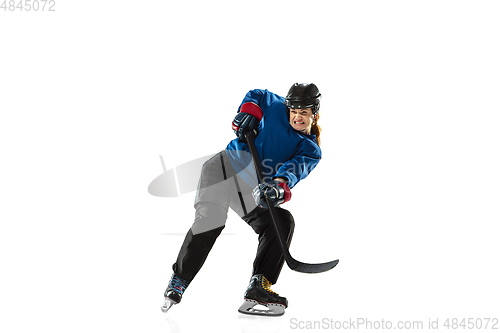 Image of Young female hockey player with the stick on ice court and white background