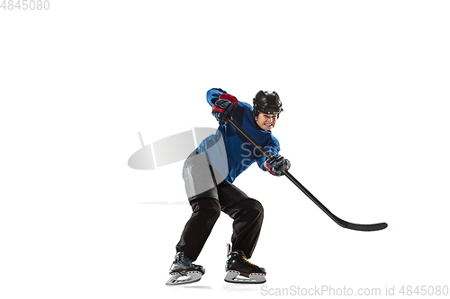 Image of Young female hockey player with the stick on ice court and white background