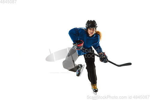 Image of Young female hockey player with the stick on ice court and white background