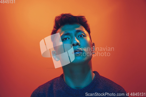 Image of Portrait of a guy with colorful neon light on gradient background - cyberpunk concept