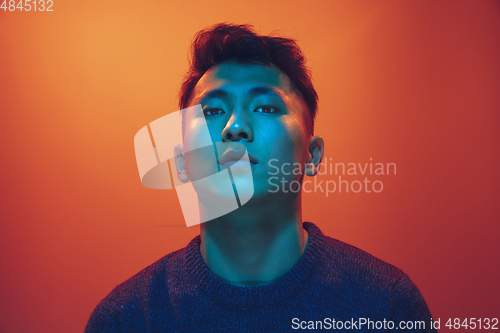 Image of Portrait of a guy with colorful neon light on gradient background - cyberpunk concept