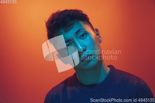 Image of Portrait of a guy with colorful neon light on gradient background - cyberpunk concept