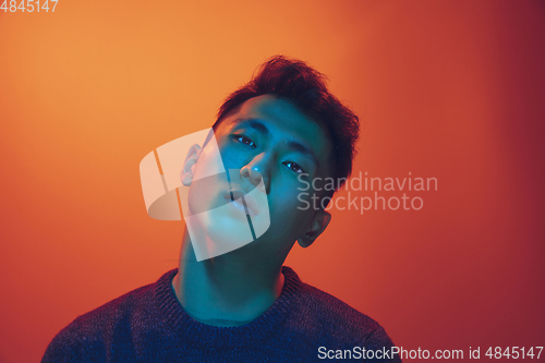 Image of Portrait of a guy with colorful neon light on gradient background - cyberpunk concept