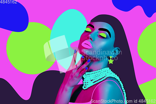 Image of Portrait of a beautiful young woman with bright colorful painted design