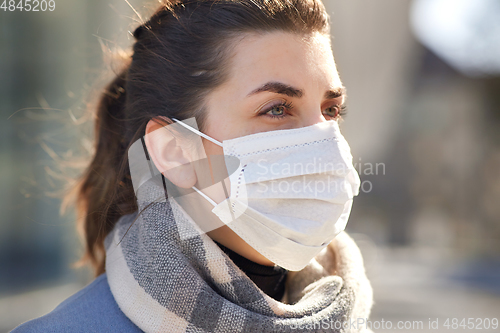 Image of young woman wearing protective medical mask