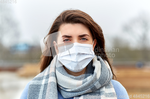 Image of young woman wearing protective medical mask