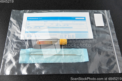 Image of beaker with test, cotton swab and medical report