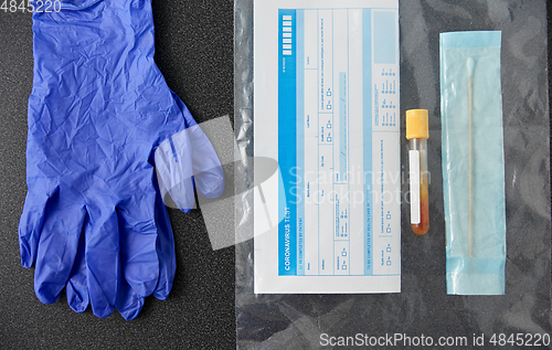 Image of test tube, cotton swab, medical report and gloves