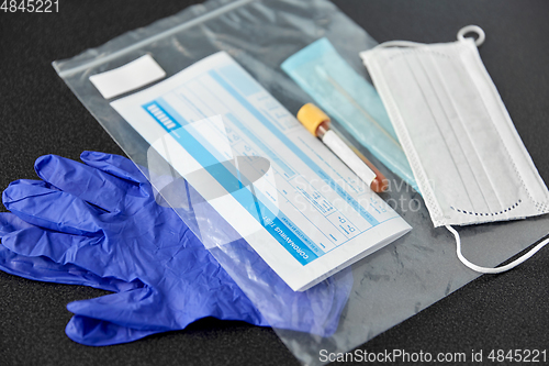 Image of test tube, medical report, gloves and mask