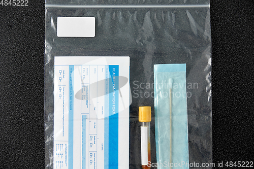 Image of beaker with test, cotton swab and medical report