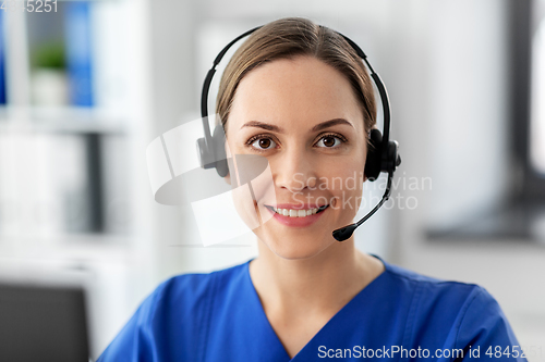 Image of doctor with headset and computer at hospital