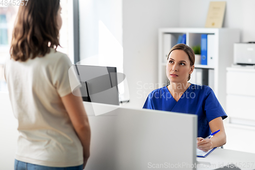 Image of doctor with computer and patient at hospital