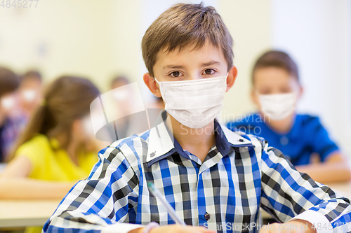 Image of student boy in protective medical mask at school