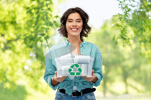 Image of smiling young woman sorting metallic waste