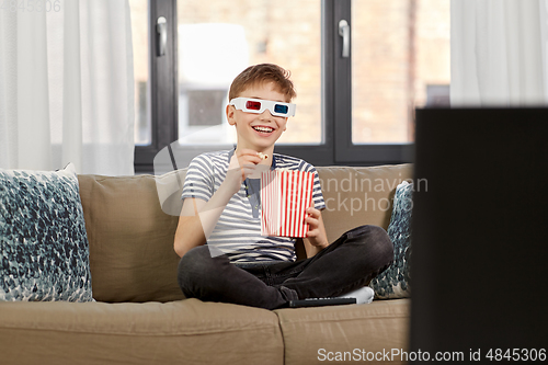 Image of boy in 3d movie glasses and watching tv at home