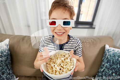 Image of boy in 3d movie glasses and watching tv at home