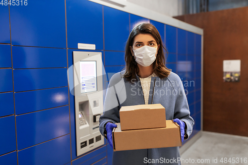 Image of woman in mask with boxes at parcel machine