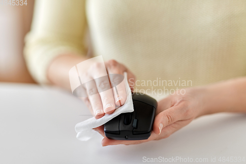 Image of close up of woman cleaning computer mouse