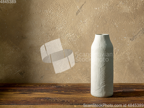 Image of white vase on wooden table