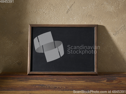 Image of blackboard in a wooden frame on a table