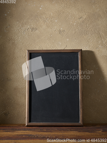 Image of blackboard in a wooden frame on a table